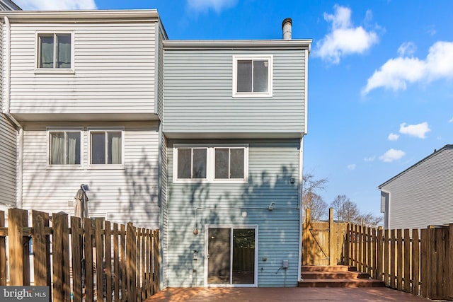 rear view of property with a fenced backyard