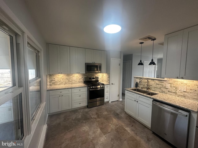 kitchen featuring visible vents, a sink, stainless steel appliances, white cabinetry, and backsplash