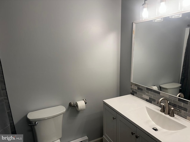 bathroom featuring tasteful backsplash, vanity, and toilet