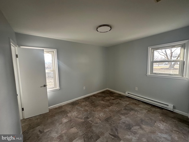 unfurnished bedroom featuring baseboards and baseboard heating