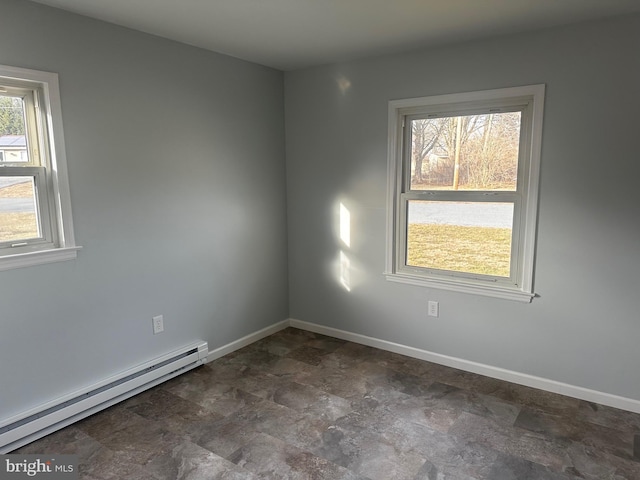 spare room with baseboards and a baseboard heating unit