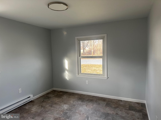 spare room with baseboard heating and baseboards