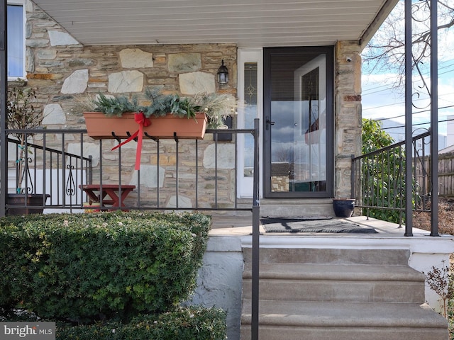 property entrance featuring stone siding