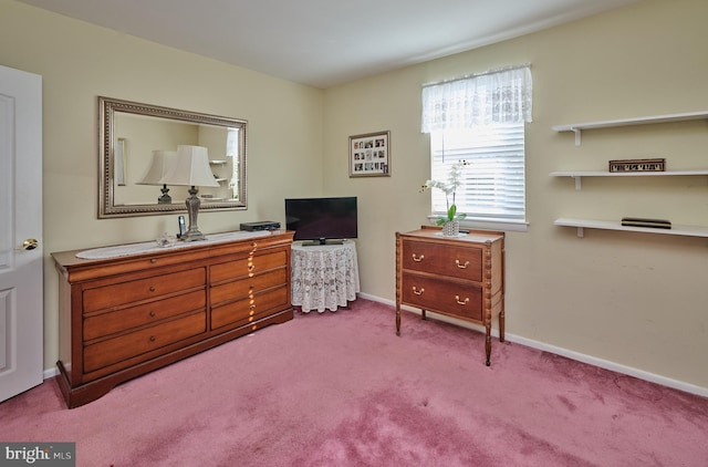 bedroom featuring light carpet and baseboards