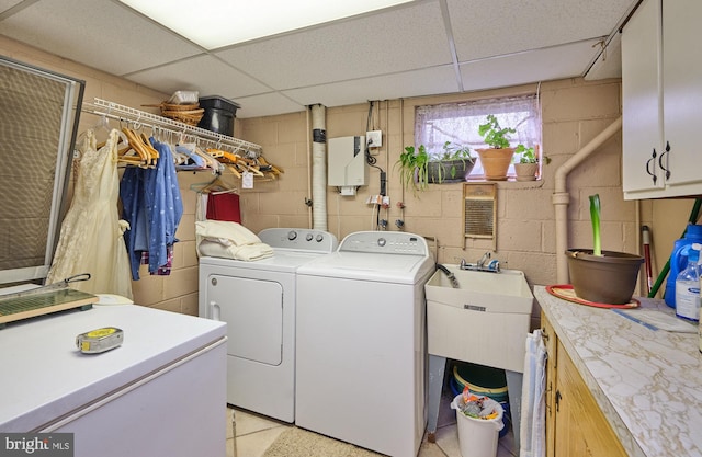 laundry room featuring cabinet space and separate washer and dryer