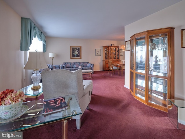 carpeted living area featuring baseboards