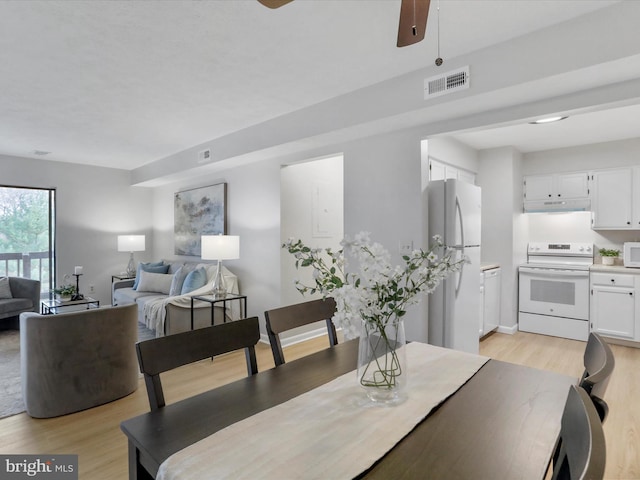 dining area featuring a ceiling fan, visible vents, and light wood-style floors