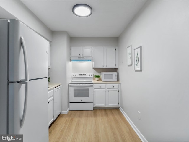 kitchen with under cabinet range hood, white appliances, baseboards, white cabinets, and light countertops