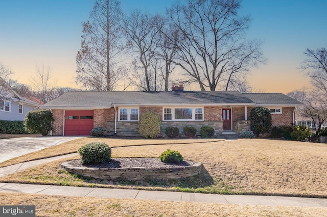 ranch-style home with brick siding, driveway, an attached garage, and a chimney