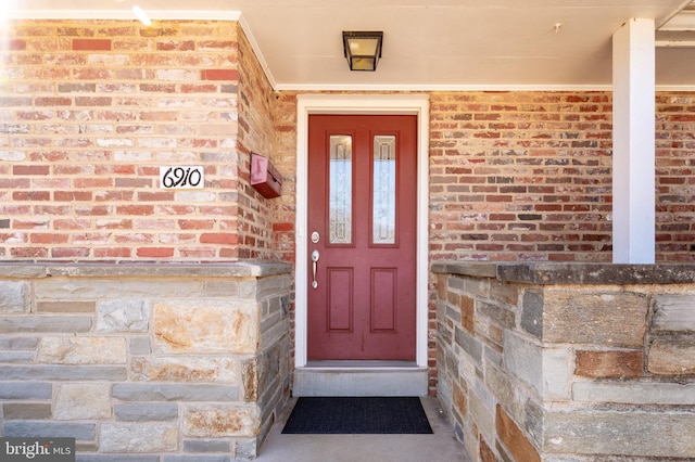 property entrance with brick siding