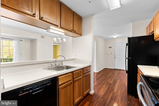 kitchen featuring dark wood-type flooring, a sink, visible vents, black dishwasher, and light countertops