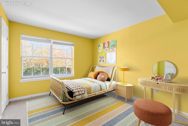 bedroom with carpet floors and baseboards