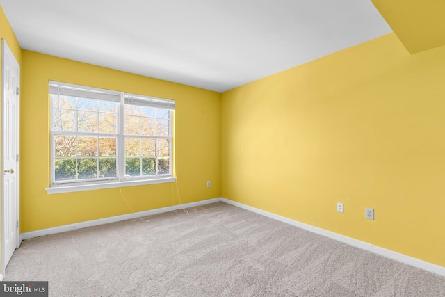 carpeted empty room with baseboards