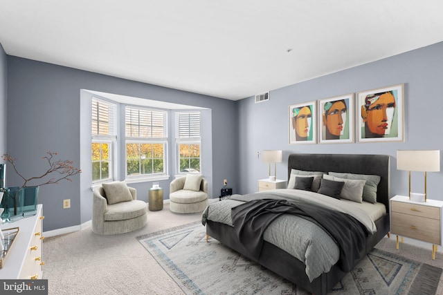 bedroom with baseboards, visible vents, and light colored carpet