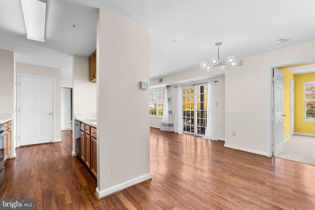 interior space with hanging light fixtures, brown cabinetry, plenty of natural light, and light countertops