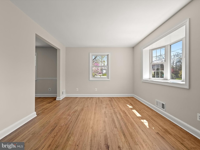unfurnished room with visible vents, baseboards, and light wood-style floors