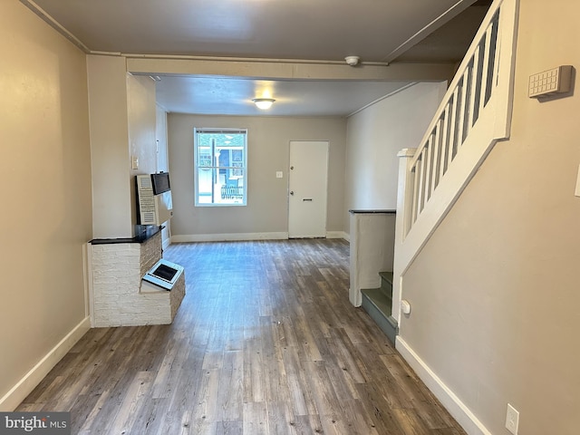 entryway featuring stairway, wood finished floors, and baseboards