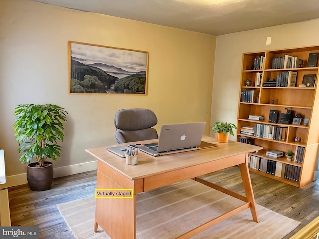 office area featuring baseboards and wood finished floors