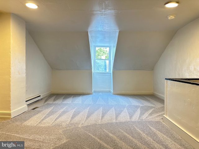 bonus room with a baseboard heating unit, carpet floors, lofted ceiling, and baseboards