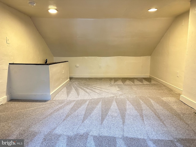 bonus room with vaulted ceiling, carpet flooring, and baseboards