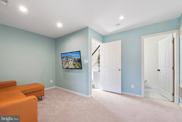 sitting room with light colored carpet, visible vents, baseboards, and recessed lighting