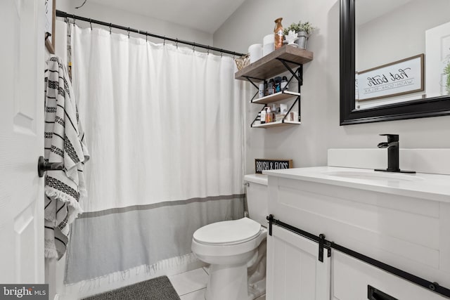 full bath with a shower with shower curtain, vanity, toilet, and tile patterned floors