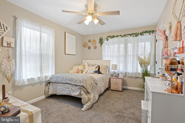 bedroom with a ceiling fan, light carpet, and baseboards