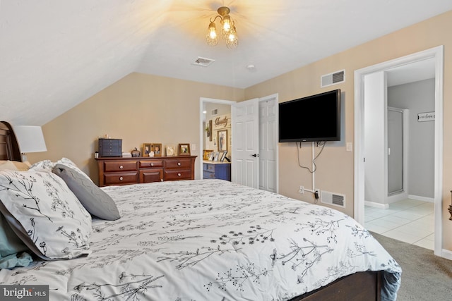 carpeted bedroom with tile patterned flooring, visible vents, vaulted ceiling, and baseboards