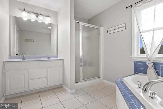 bathroom featuring a bath, a stall shower, tile patterned flooring, and a wealth of natural light