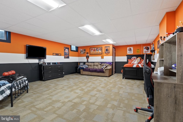 carpeted living room with a drop ceiling