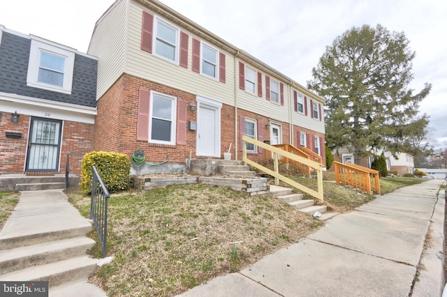 multi unit property featuring brick siding and a shingled roof