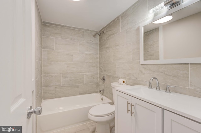 full bathroom featuring toilet, tasteful backsplash, tile walls, bathtub / shower combination, and vanity