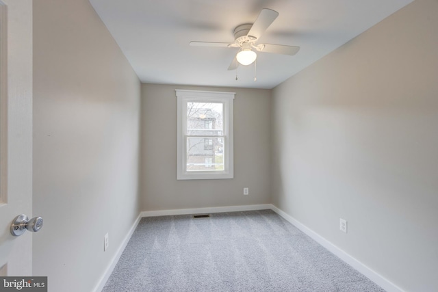 unfurnished room featuring baseboards, a ceiling fan, and carpet flooring