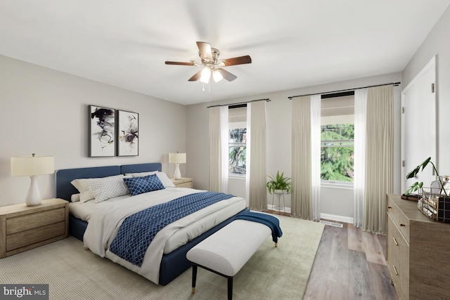 bedroom featuring ceiling fan, wood finished floors, and baseboards