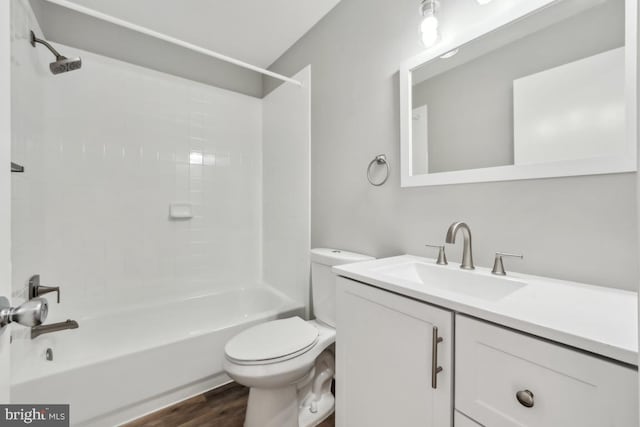 full bath with toilet, shower / bathtub combination, wood finished floors, and vanity