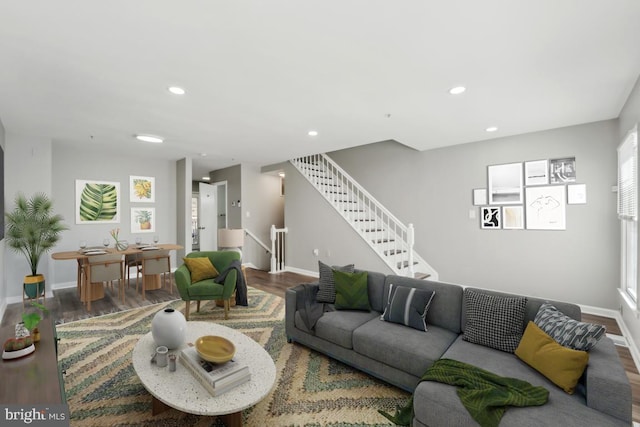 living area with stairway, wood finished floors, and recessed lighting