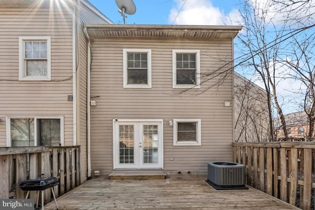 rear view of property with french doors, cooling unit, and a wooden deck