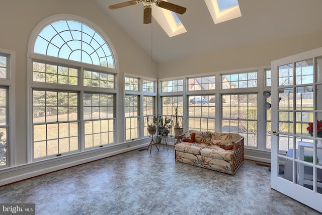 sunroom featuring lofted ceiling with skylight and a ceiling fan