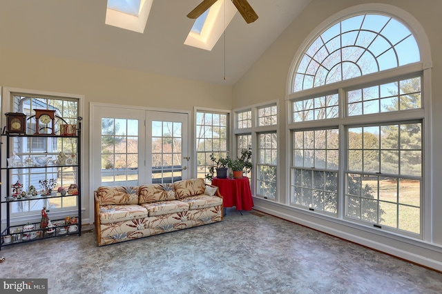 unfurnished sunroom featuring ceiling fan and vaulted ceiling with skylight