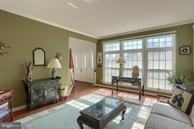 living room with ornamental molding, a wealth of natural light, and wood finished floors