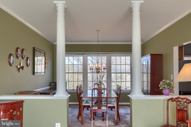 dining area featuring baseboards, an inviting chandelier, decorative columns, and crown molding