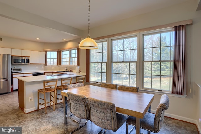 dining space featuring recessed lighting, a toaster, and baseboards