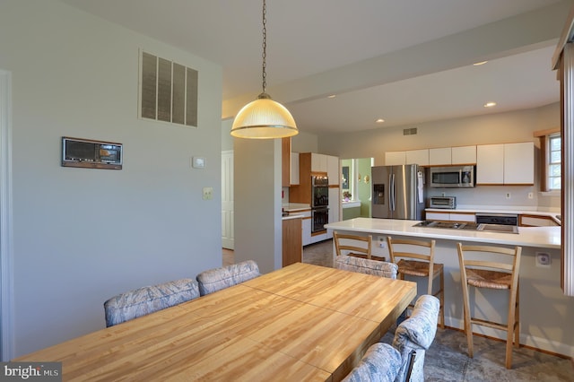 dining area with a toaster, visible vents, and recessed lighting