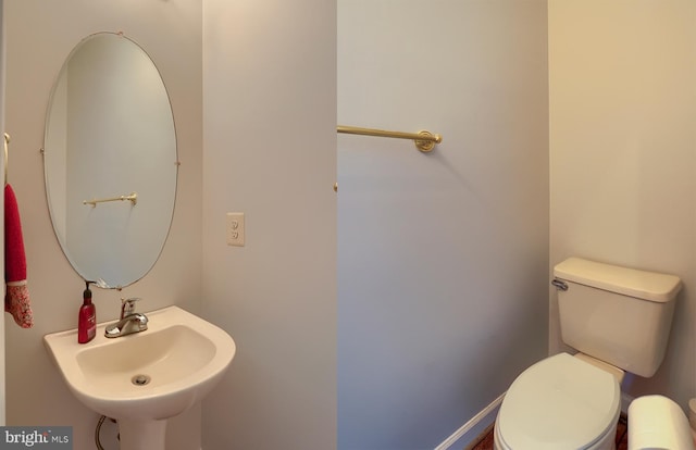 half bath with a sink and toilet