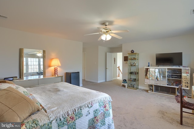 carpeted bedroom featuring visible vents, ceiling fan, and baseboards