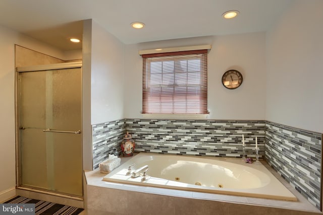 bathroom with a jetted tub, a stall shower, and recessed lighting