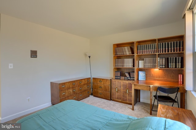 bedroom featuring baseboards and light colored carpet