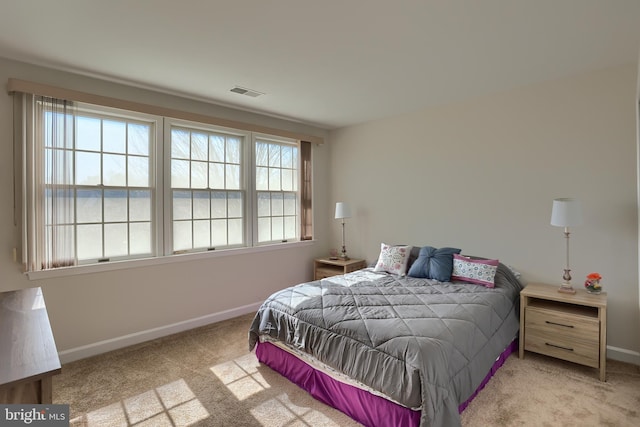 bedroom with carpet, visible vents, and baseboards