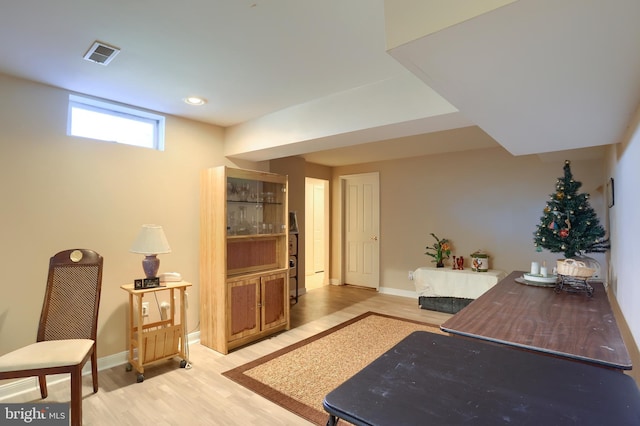 interior space featuring light wood-style flooring, visible vents, and baseboards