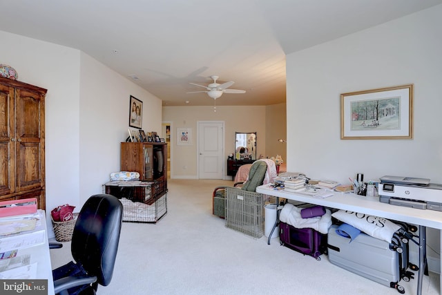 office featuring a ceiling fan and light colored carpet